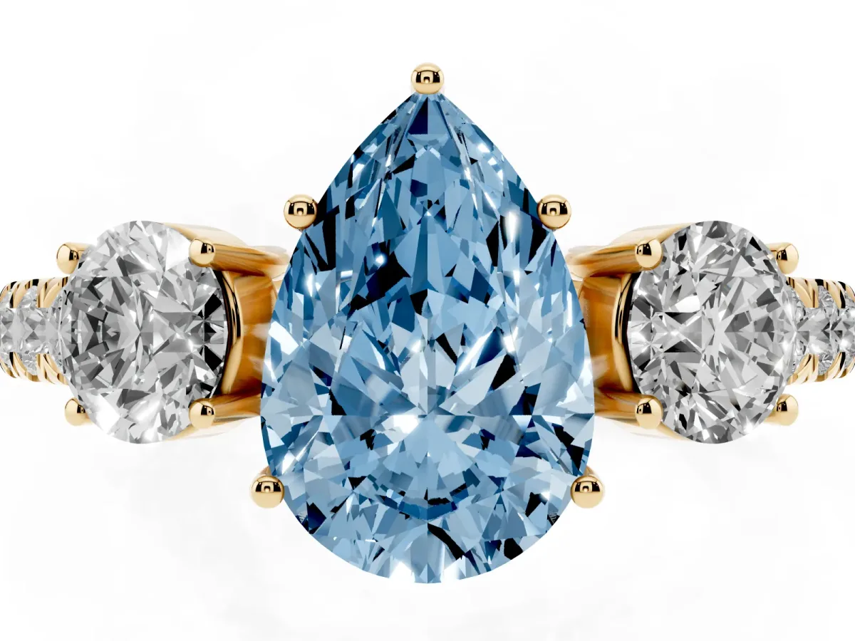 Fancy Blue Pear Cut Cut Diamond Three-Stone Ring with Round Side Stones and Pavé Band Yellow gold