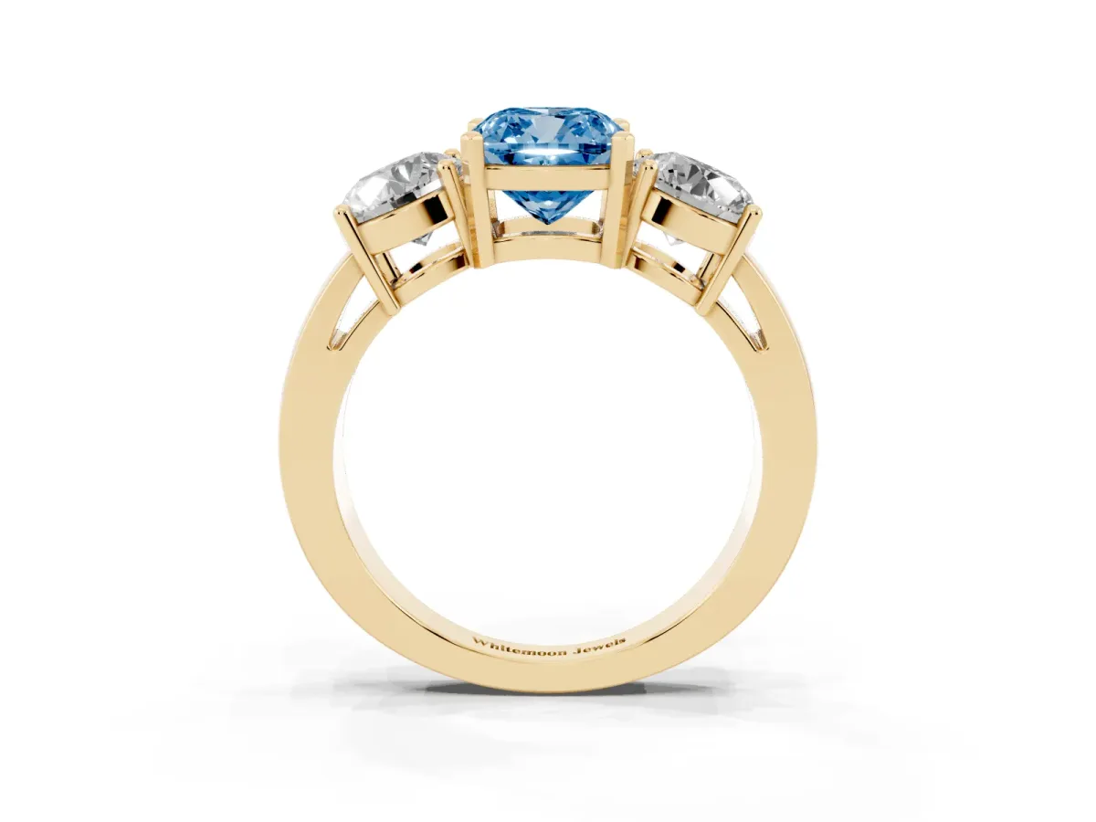 Fancy Blue Three-Stone Cushion Cut Diamond Ring with Round Side Stones, Classic Band, and Four-Prong Setting Yellow gold