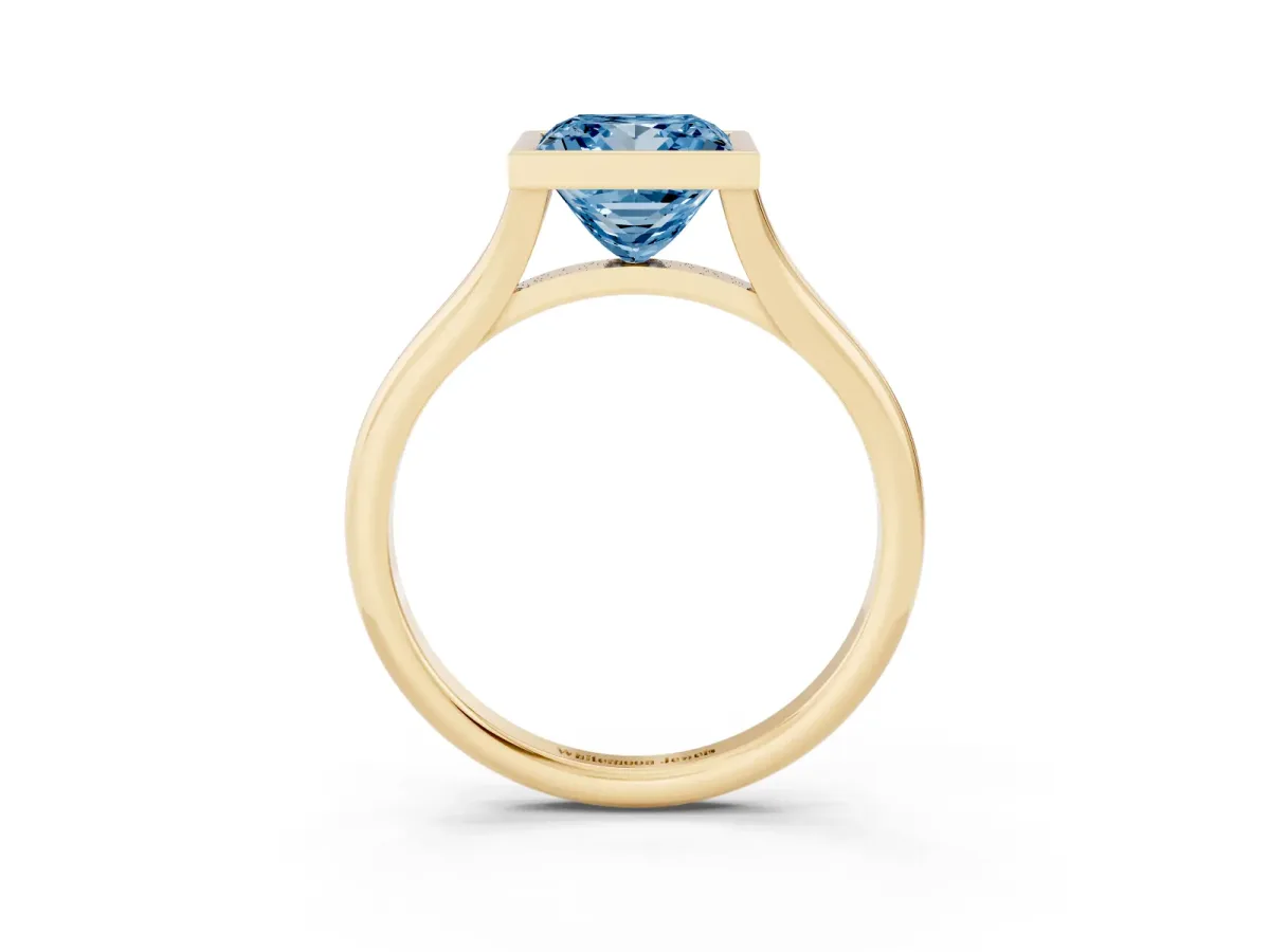 Fancy Blue Bezel Set Princess Cut Cut Solitaire Ring with Tapered Band Yellow gold