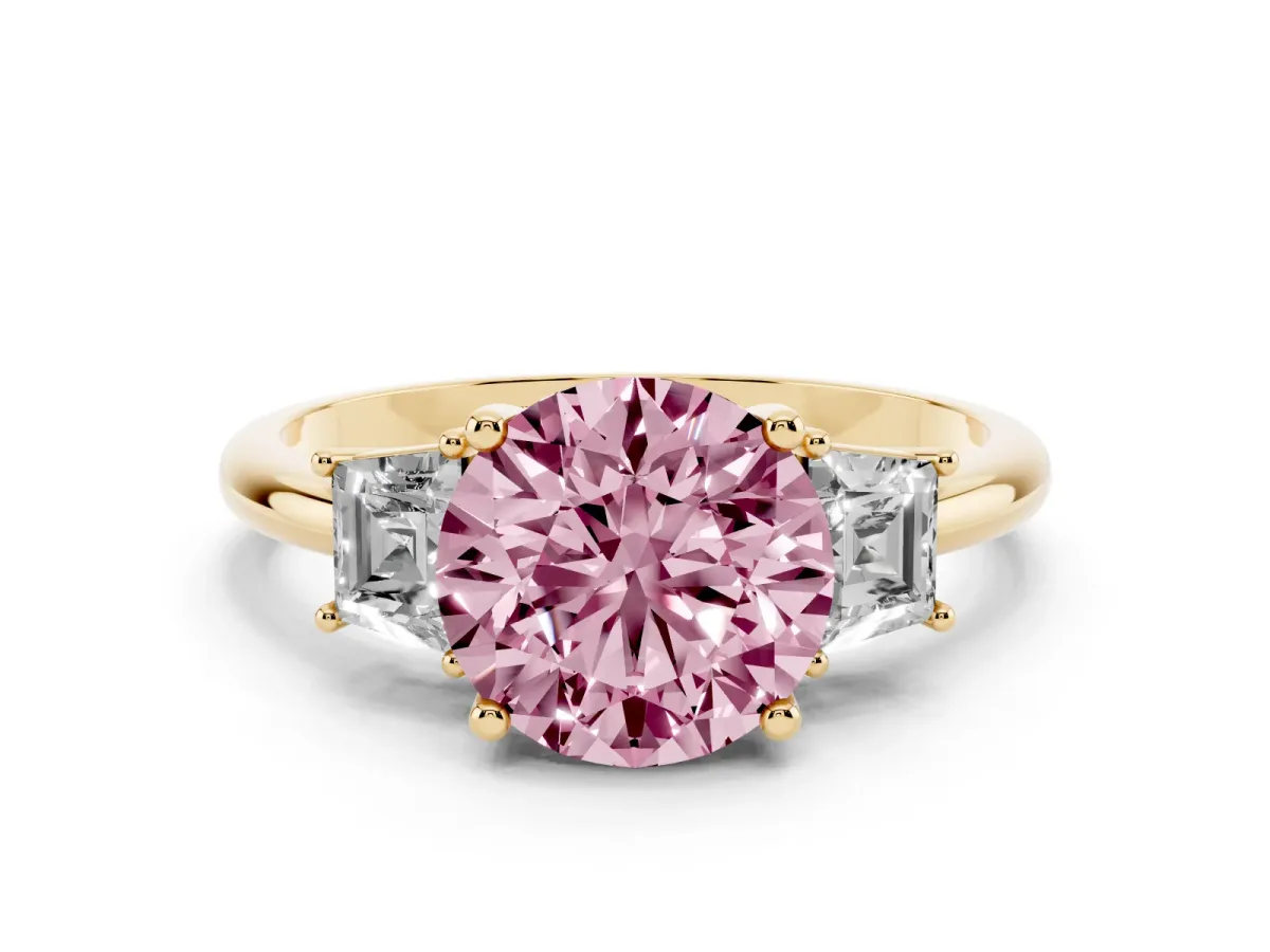 Fancy Pink Round Cut Diamond Three-Stone Ring with Trapezoid Side Stones and Prong Setting Yellow gold