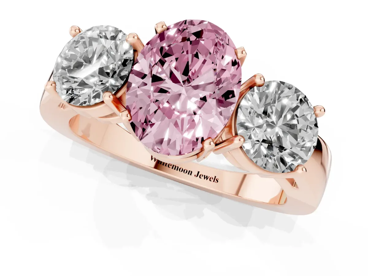 Fancy Pink Three-Stone Oval Cut Diamond Ring with Round Side Stones, Classic Band, and Four-Prong Setting Rose gold