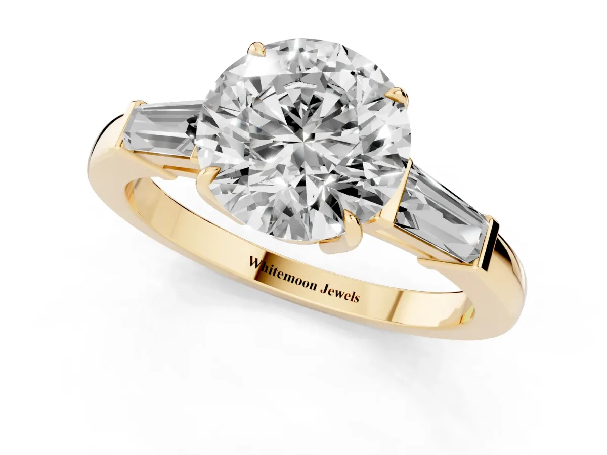 Round Cut Diamond Three-Stone Ring with Tapered Baguette Side Stones and Prong Setting Yellow gold