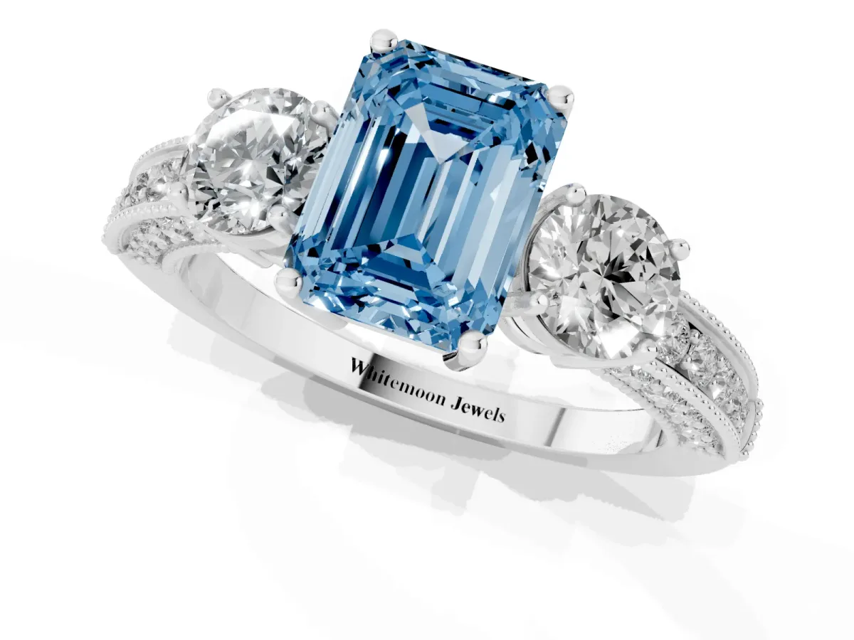 Fancy Blue Emerald Cut Three-Stone Diamond Ring with Pavé Band and Four-Prong Setting Silver