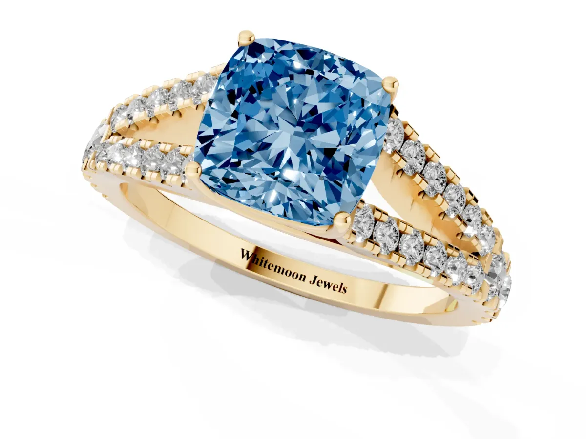 Fancy Blue Cushion Cut Diamond Split Shank Engagement Ring with Round Pavé and Prong Setting Yellow gold