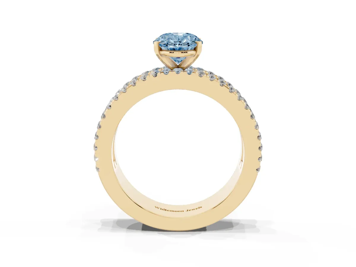Fancy Blue Oval Cut Diamond Solitaire Ring with Pavé and Channel Set Band Yellow gold