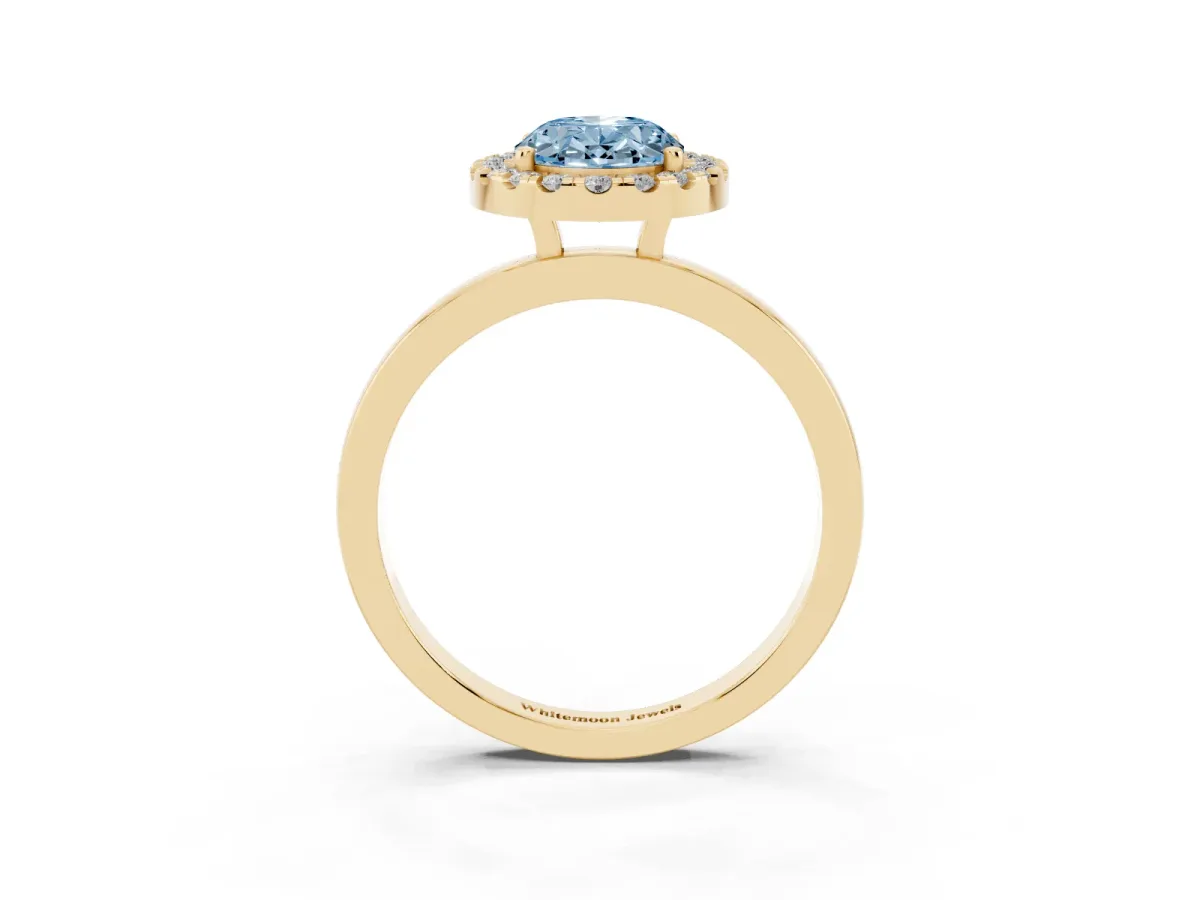 Fancy Blue Oval Cut Halo Diamond Solitaire with Pavé Band and Four-Prong Setting Yellow gold
