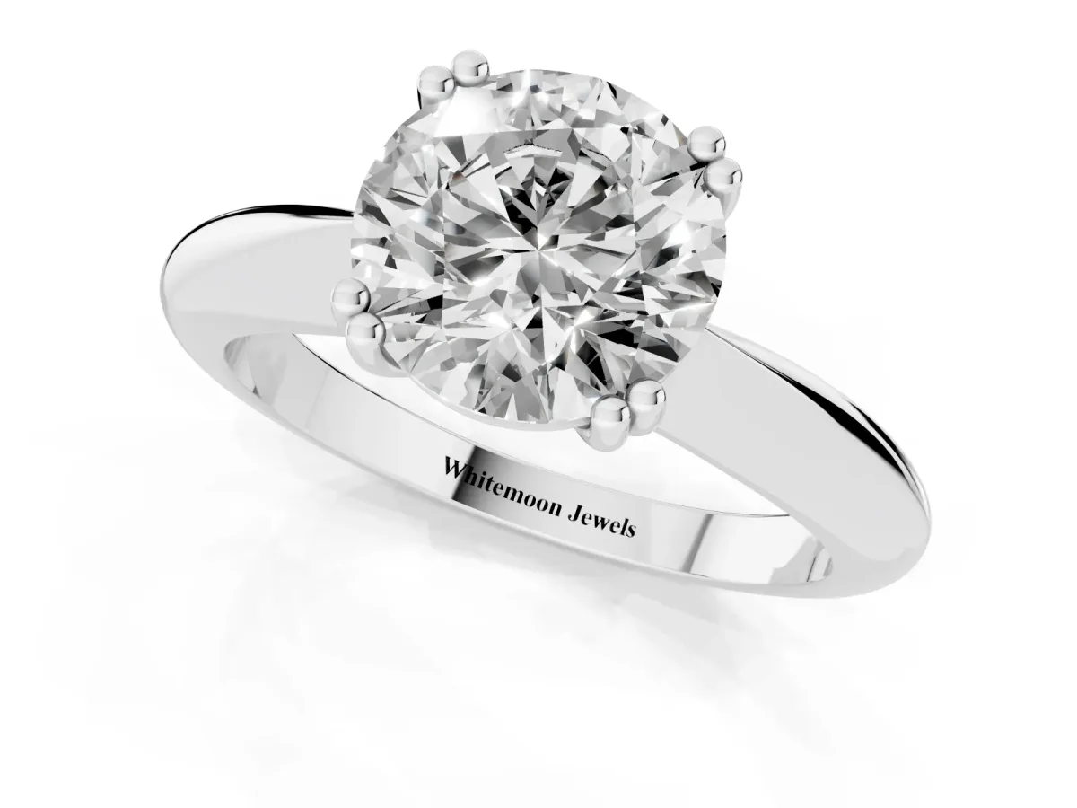 Round Cut Cut Solitaire Engagement Ring with Tapered Band and Four-Prong Setting Platinum