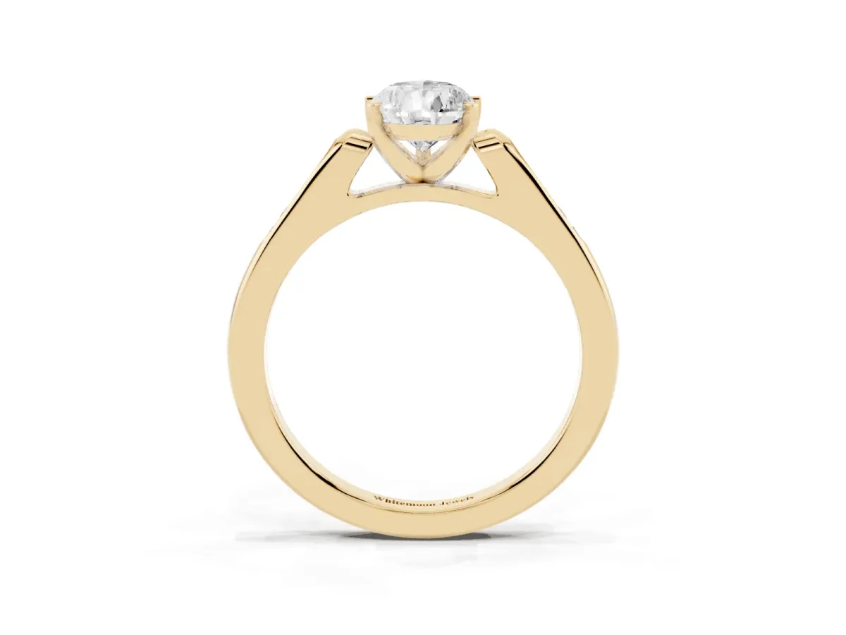 Pear Cut Diamond Solitaire Ring with Channel Set Round Band and Prong Setting Yellow gold