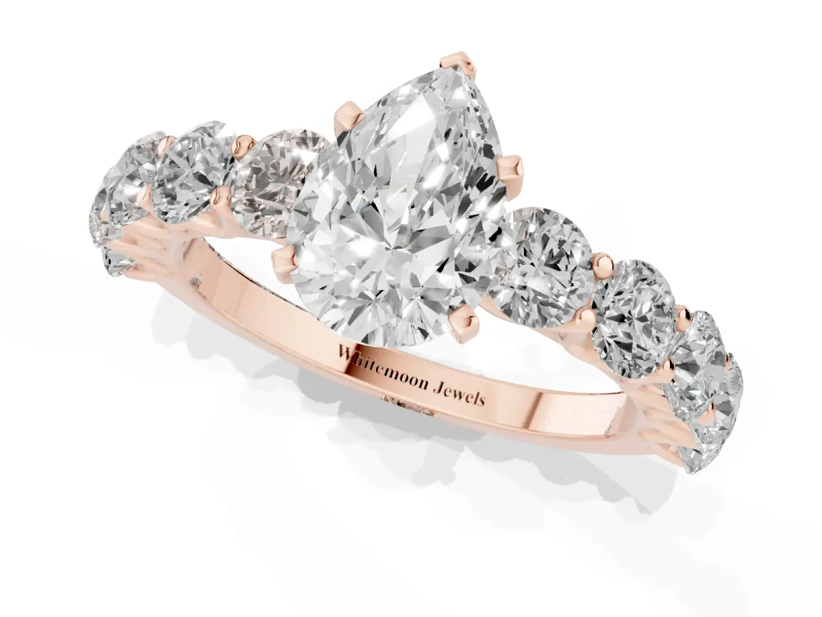 Pear Cut Diamond Prong Setting with Side Stones on a Pave Band Rose gold