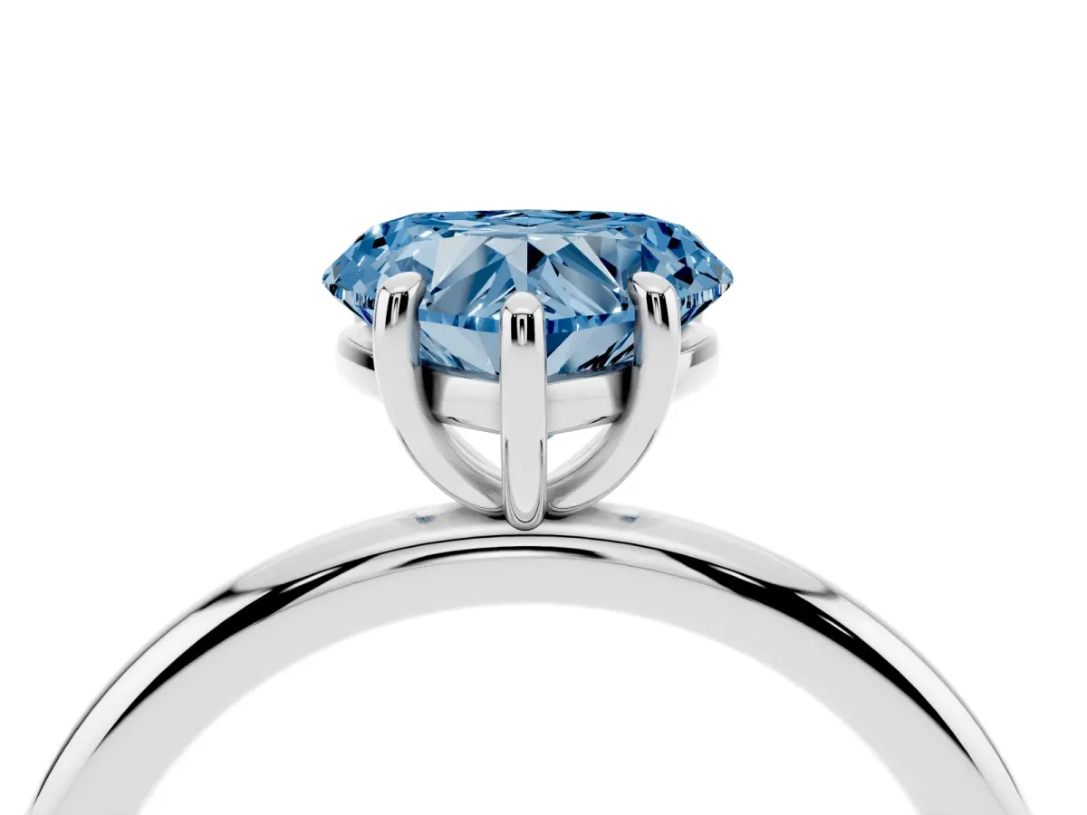 Fancy Blue Heart Cut Solitaire Diamond Ring with Four-Prong Setting on a Plain Band Platinum
