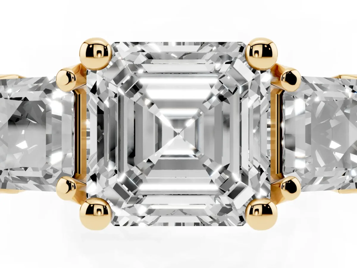 Asscher Cut Diamond Three-Stone Ring with Channel Set Band and Four-Prong Setting Yellow gold