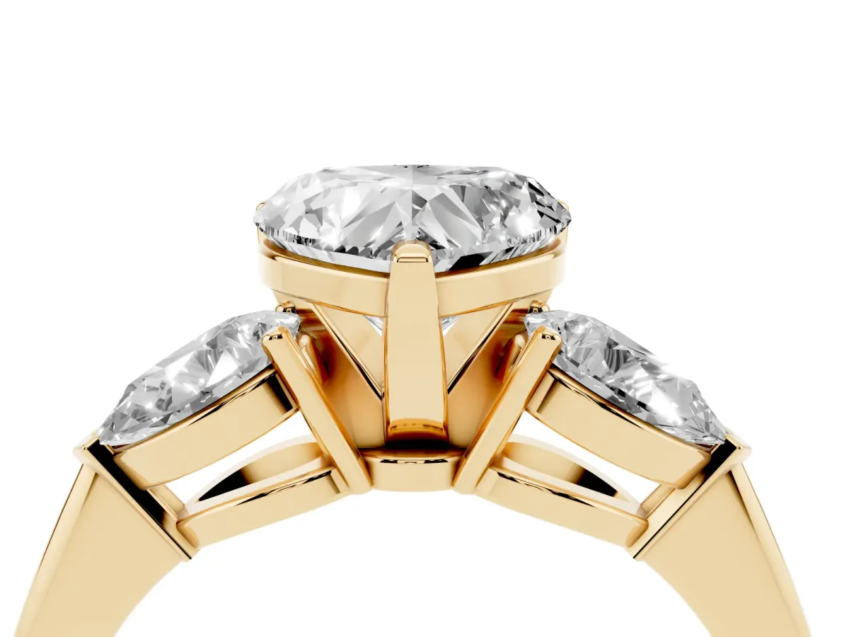 Three-Stone Heart Cut Diamond Ring with Pear Side Stones and Four-Prong Setting Yellow gold
