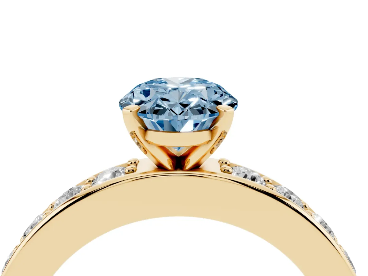 Fancy Blue Oval Cut Diamond Engagement Ring with Channel Set Round Band and Prong Setting Yellow gold