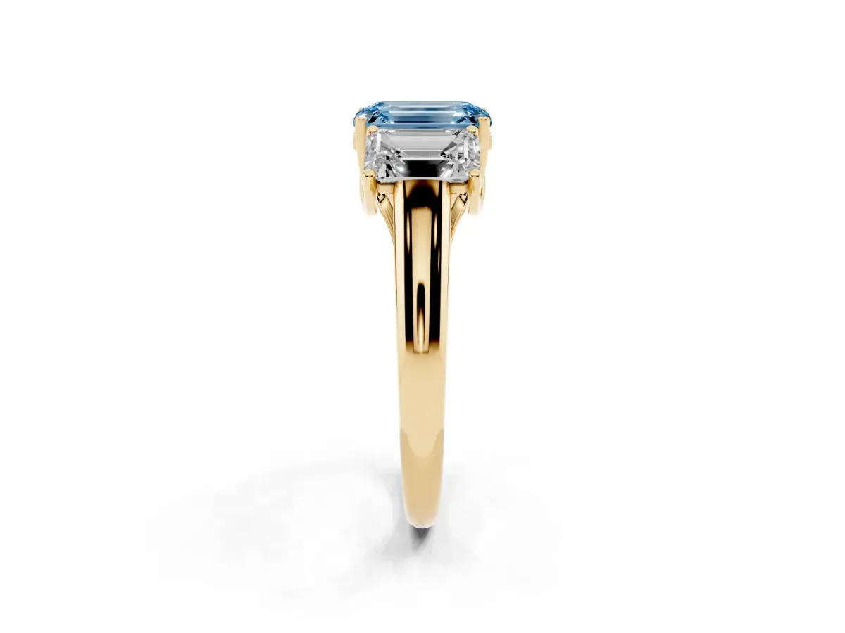 Fancy Blue Three-Stone Emerald Cut Diamond Engagement Ring with Prong Setting Yellow gold