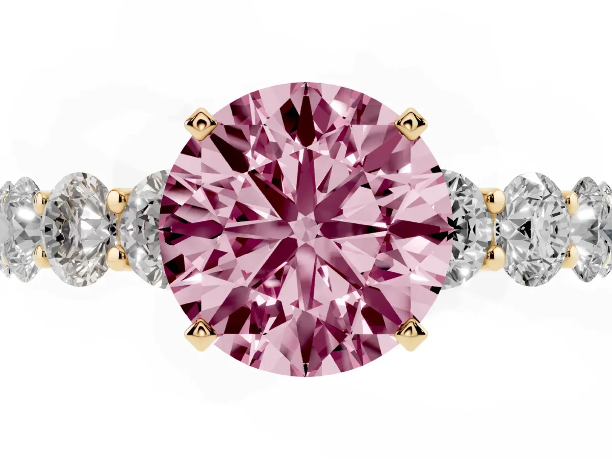 Fancy Pink Round Cut Diamond Prong Setting with Side Stones on a Pave Band Yellow gold