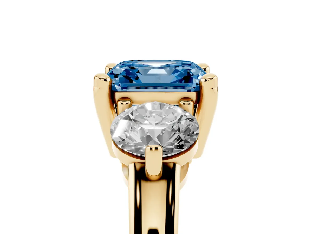 Fancy Blue Three-Stone Asscher Cut Brilliant Cut Solitaire Ring with Prong Setting on a Classic Band Yellow gold