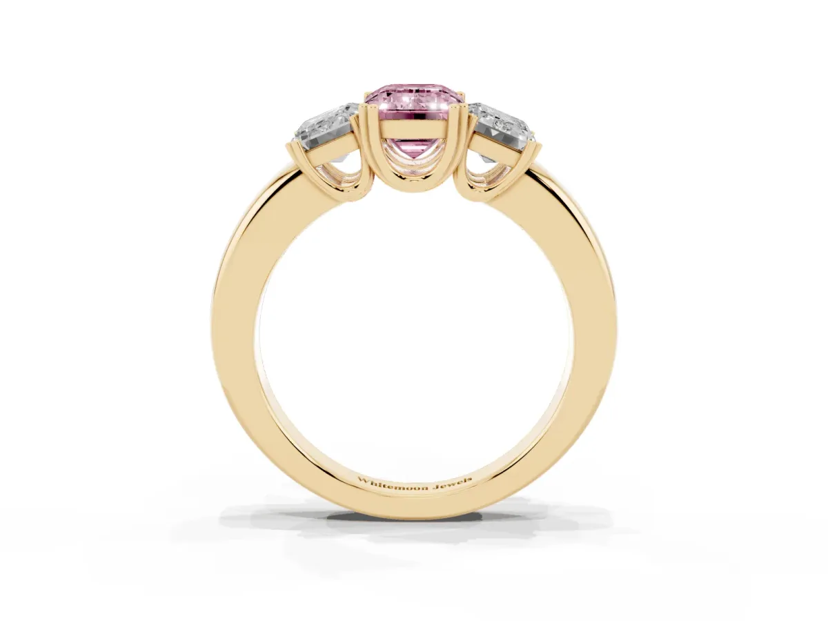 Fancy Pink Three-Stone Emerald Cut Cut Diamond Ring with Channel Set Band and Four-Prong Setting Yellow gold