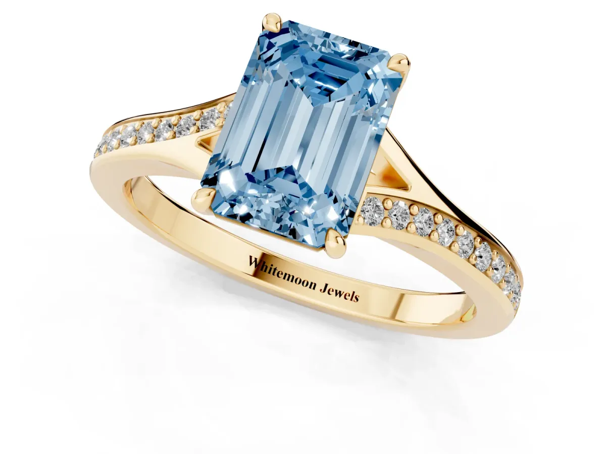 Fancy Blue Emerald Cut Diamond Solitaire Ring with Pavé Band and Prong Setting Yellow gold