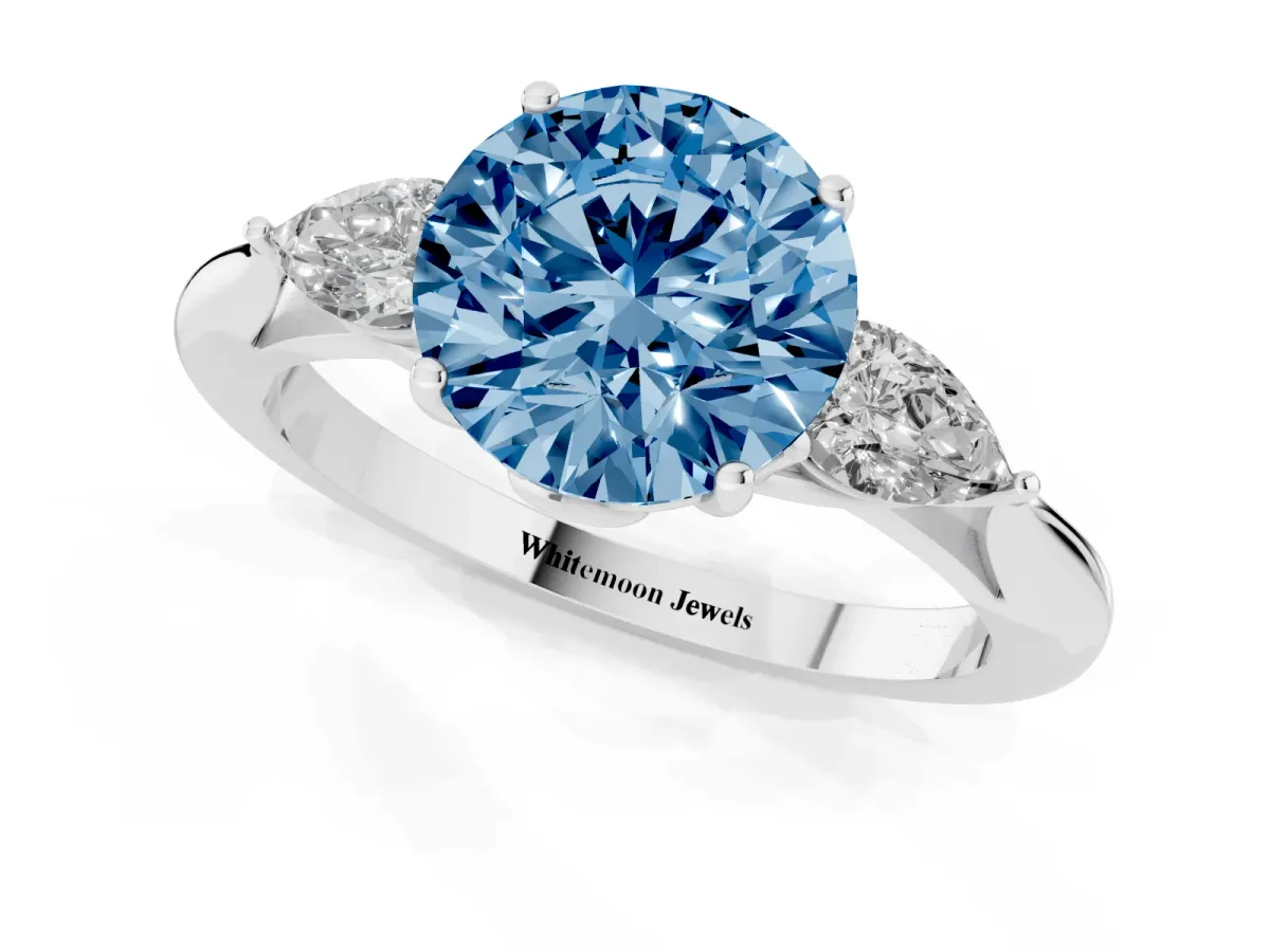 Fancy Blue Round Cut Diamond Three-Stone Ring with Pear Side Stones and Prong Setting Platinum