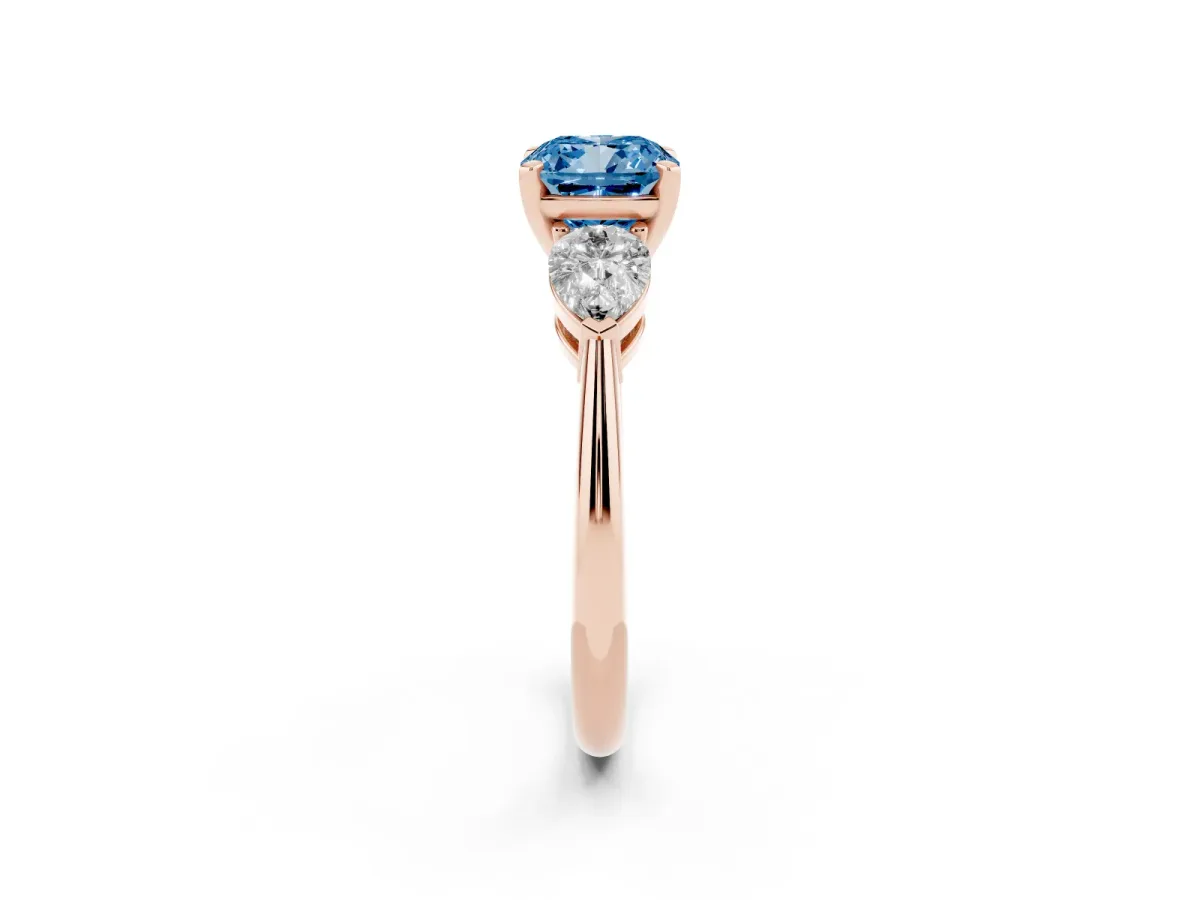 Fancy Blue Three-Stone Cushion Cut Diamond Ring with Pear Side Stones and Four-Prong Setting Rose gold