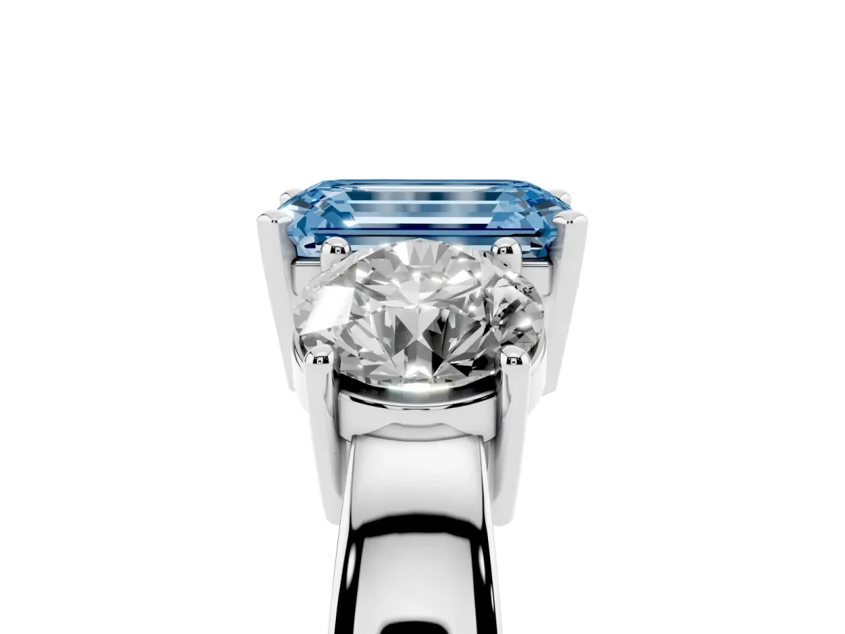 Fancy Blue Three-Stone Emerald Cut Diamond Ring with Round Side Stones, Classic Band, and Four-Prong Setting Silver