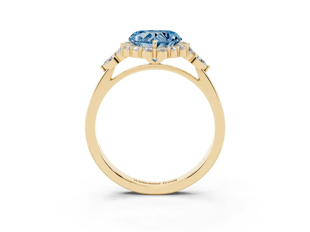 Fancy Blue Heart Cut Diamond Halo Ring with Pear Side Stones and Prong Setting Yellow gold
