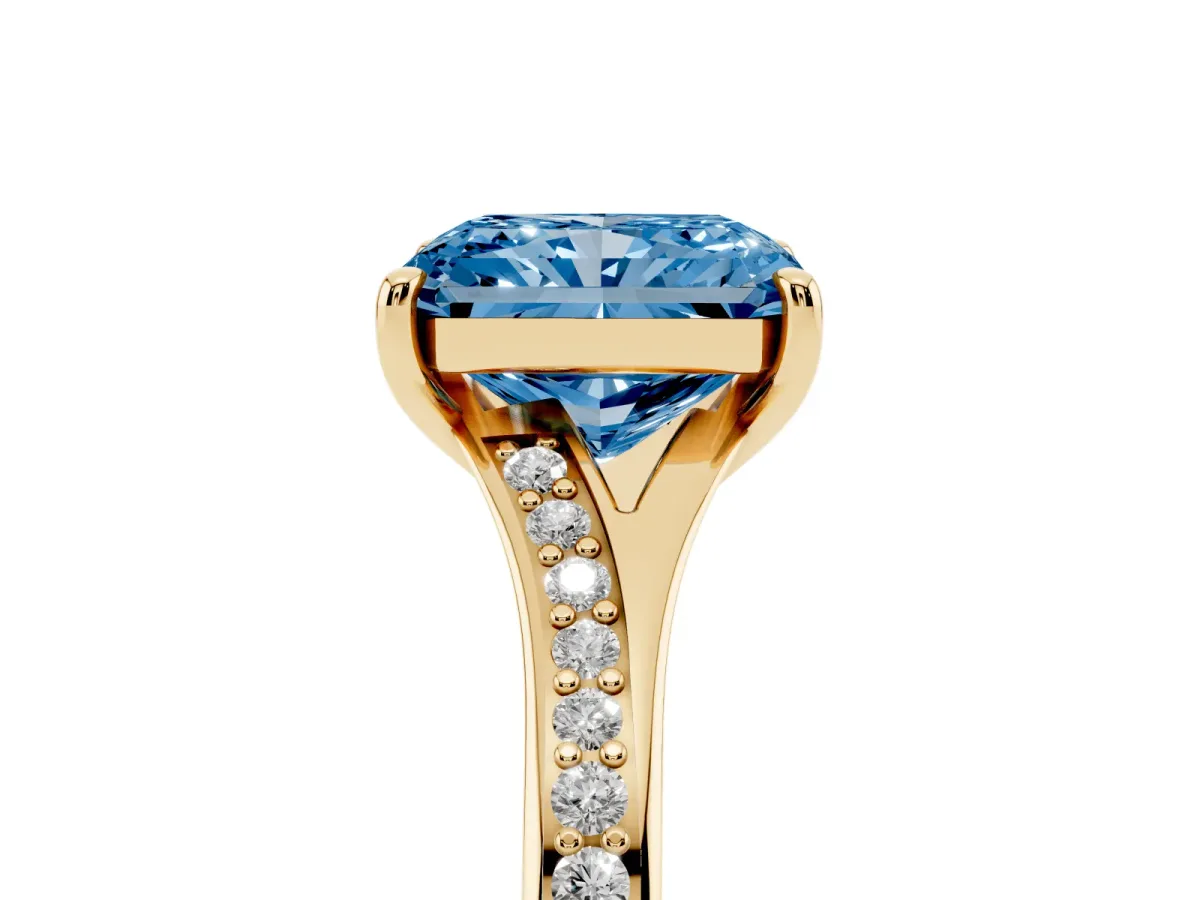 Fancy Blue Radiant Cut Diamond Solitaire Ring with Pavé Band and Prong Setting Yellow gold