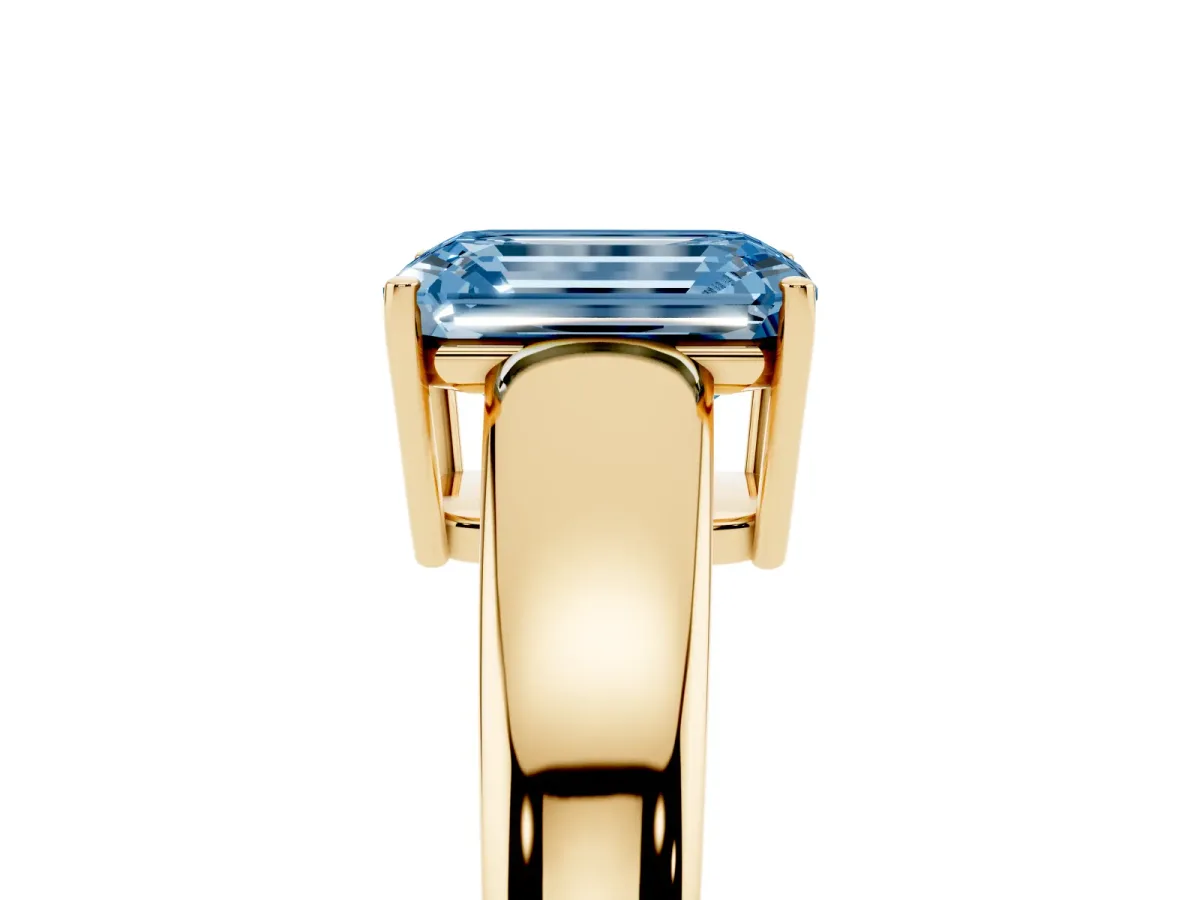 Fancy Blue Emerald Cut Solitaire Diamond Ring with Tapered Band and Four-Prong Setting Yellow gold