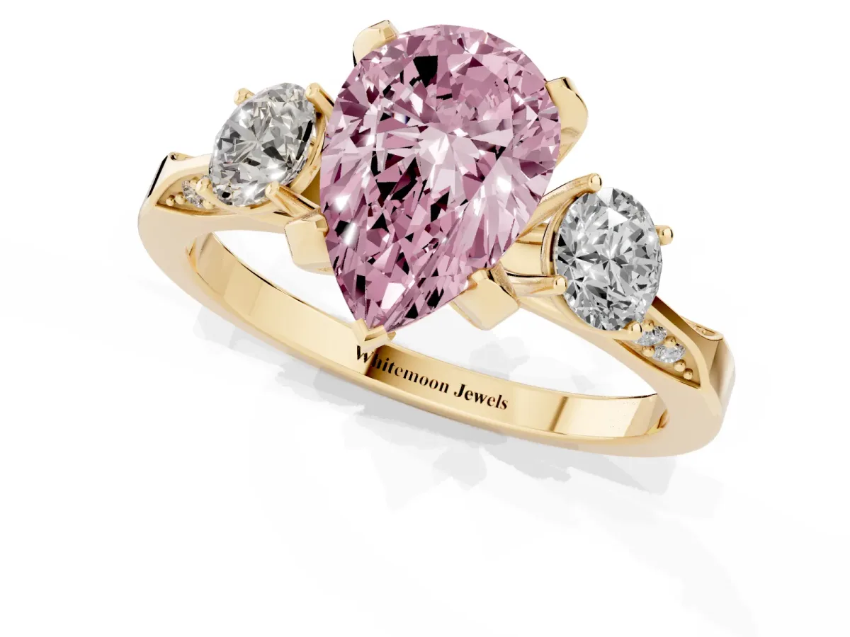 Fancy Pink Pear Cut Brilliant Three-Stone Diamond Ring with Pavé Band and Four-Prong Setting Yellow gold