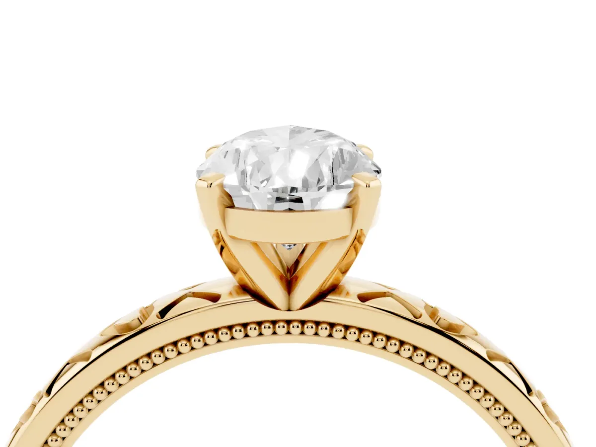 Pear Cut Solitaire Diamond Engagement Ring with XO Engraved Band and Four-Prong Setting Yellow gold