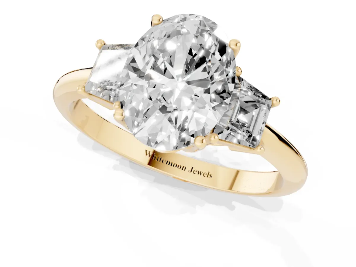 Oval Cut Diamond Three-Stone Ring with Trapezoid Side Stones and Prong Setting Yellow gold