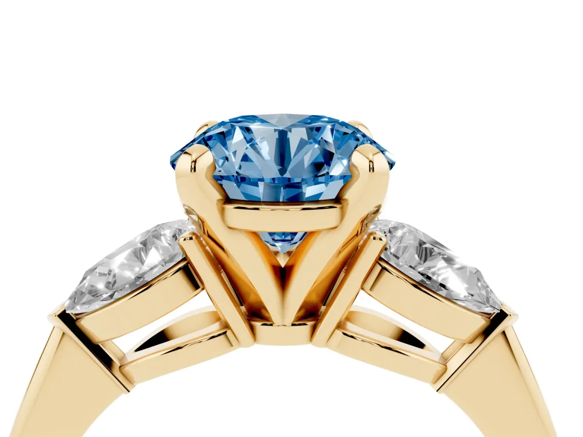 Fancy Blue Three-Stone Round Cut Diamond Ring with Pear Side Stones and Four-Prong Setting Yellow gold