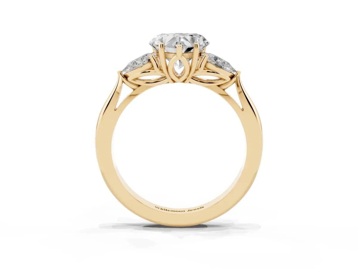 Three-Stone Heart Cut Diamond Ring with Pear Side Stones in Four-Prong Setting Yellow gold