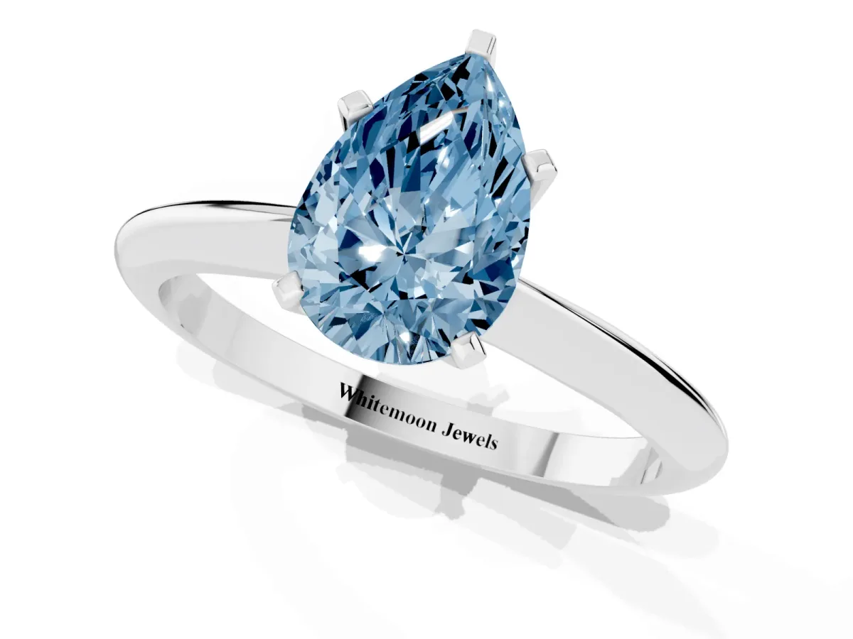 Fancy Blue Pear Cut Cut Solitaire Ring with Four-Prong Setting on a Classic Band Silver