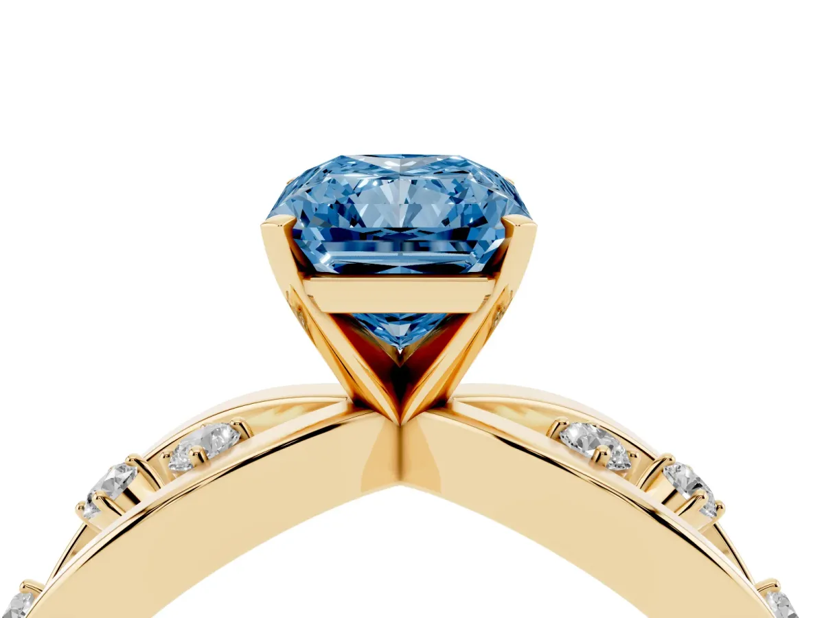 Fancy Blue Radiant Cut Cut Solitaire Diamond with Side Stones on Criss-Cross Band and Four-Prong Setting Yellow gold