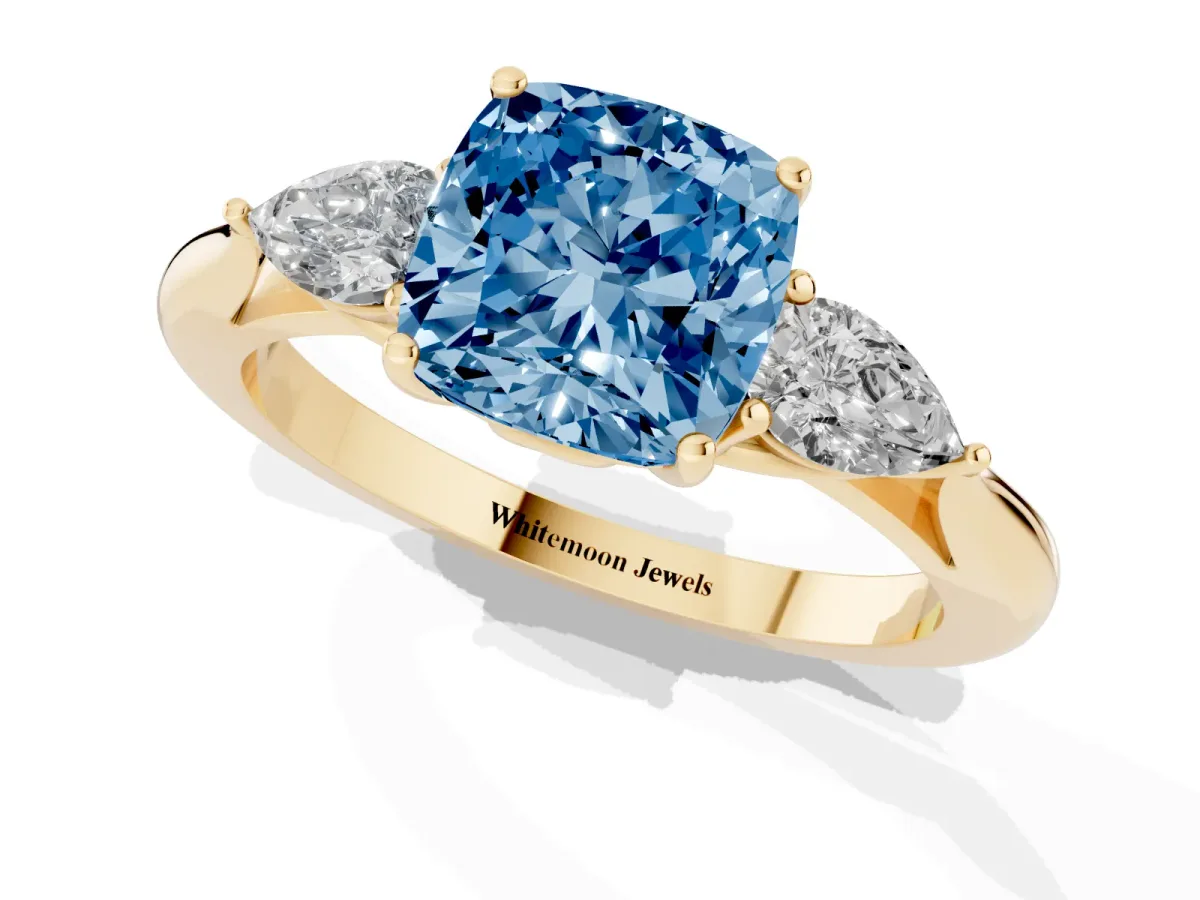 Fancy Blue Three-Stone Cushion Cut Brilliant Diamond Solitaire Ring with Tapered Band and Four-Prong Setting Yellow gold