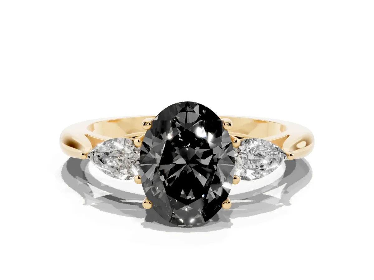 Fancy Black Three-Stone Oval Cut Brilliant Diamond Solitaire Ring with Tapered Band and Four-Prong Setting Yellow gold