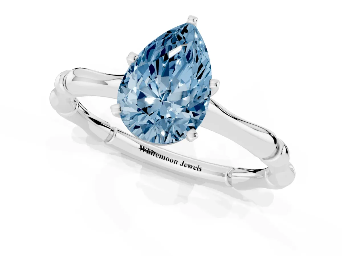 Fancy Blue Pear Cut Solitaire Diamond Ring with Bamboo Band and Four-Prong Setting Platinum