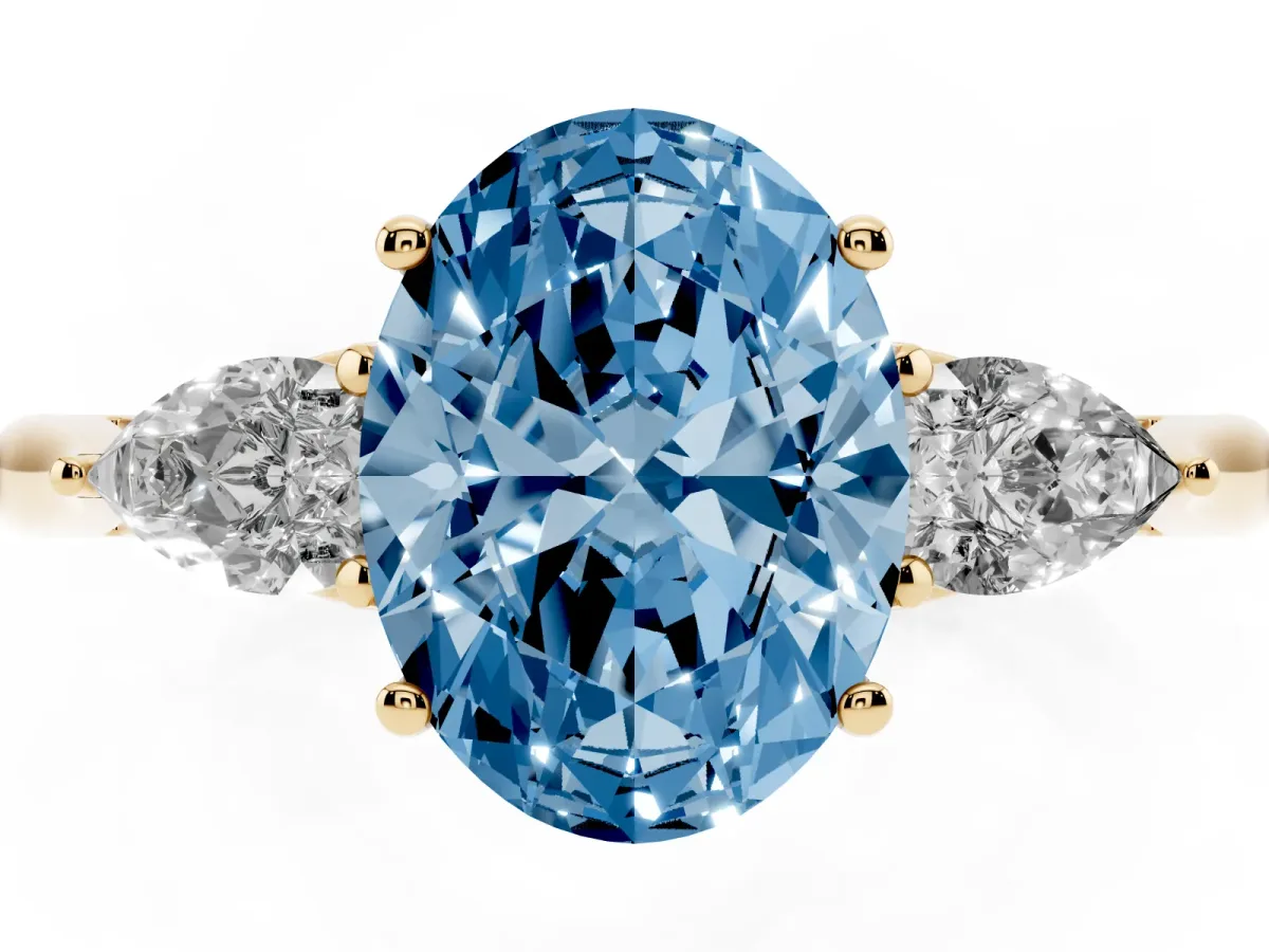 Fancy Blue Three-Stone Oval Cut Diamond Ring with Pear Side Stones in Four-Prong Setting Yellow gold