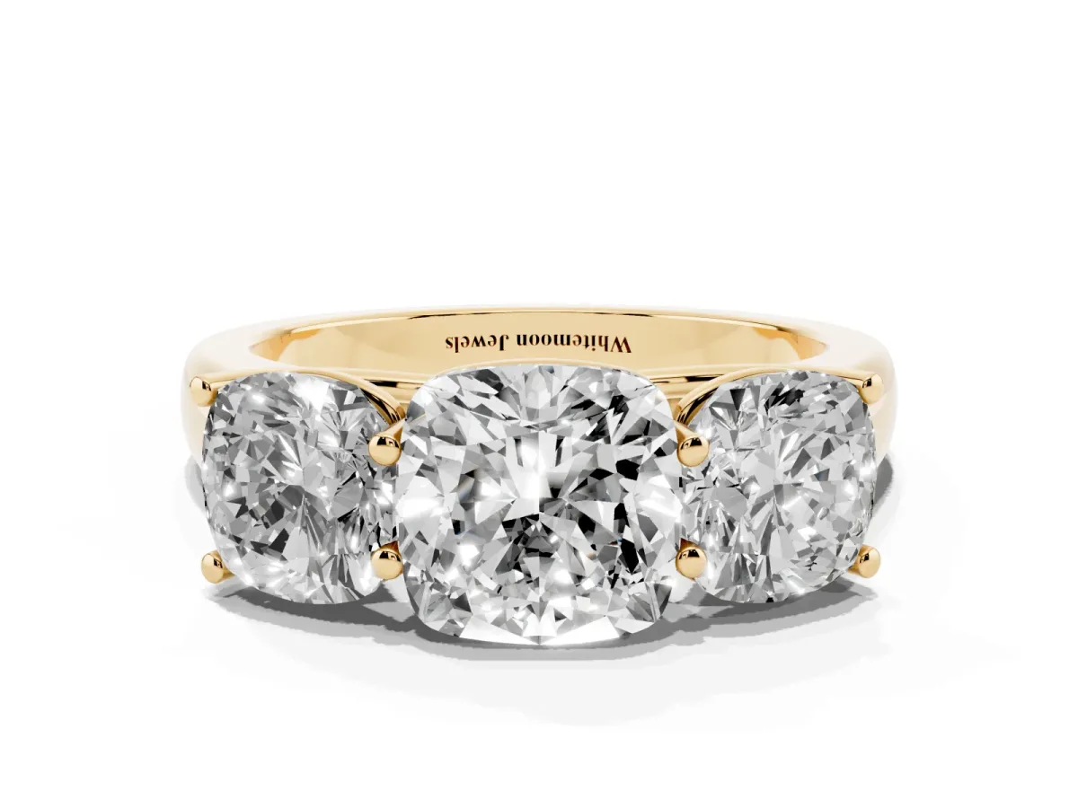 Cushion Cut Three-Stone Diamond Ring with Prong Setting on a Classic Band Yellow gold