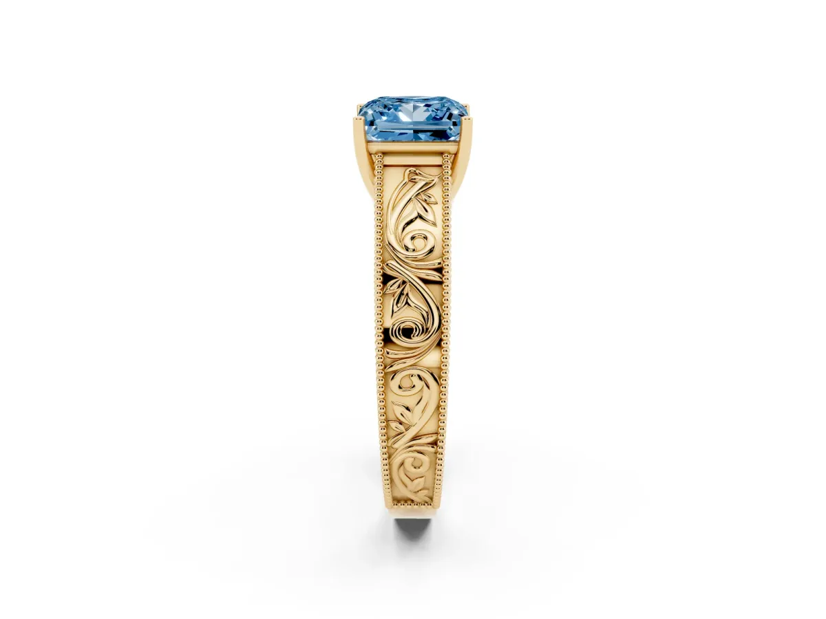 Fancy Blue Princess Cut Diamond Solitaire Ring with Engraved Band and Four-Prong Setting Yellow gold