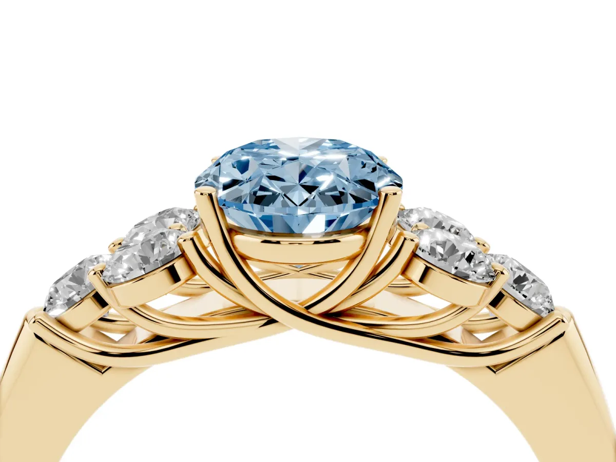 Fancy Blue Oval Cut Cut Diamond Cluster Ring with Round Accent Stones and Prong Setting on a Classic Band Yellow gold