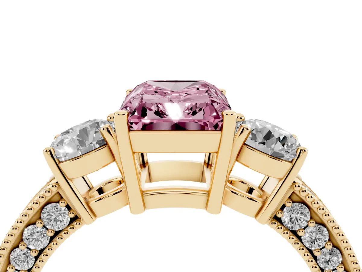 Fancy Pink Radiant Cut Three-Stone Diamond Ring with Pavé Band and Four-Prong Setting Yellow gold