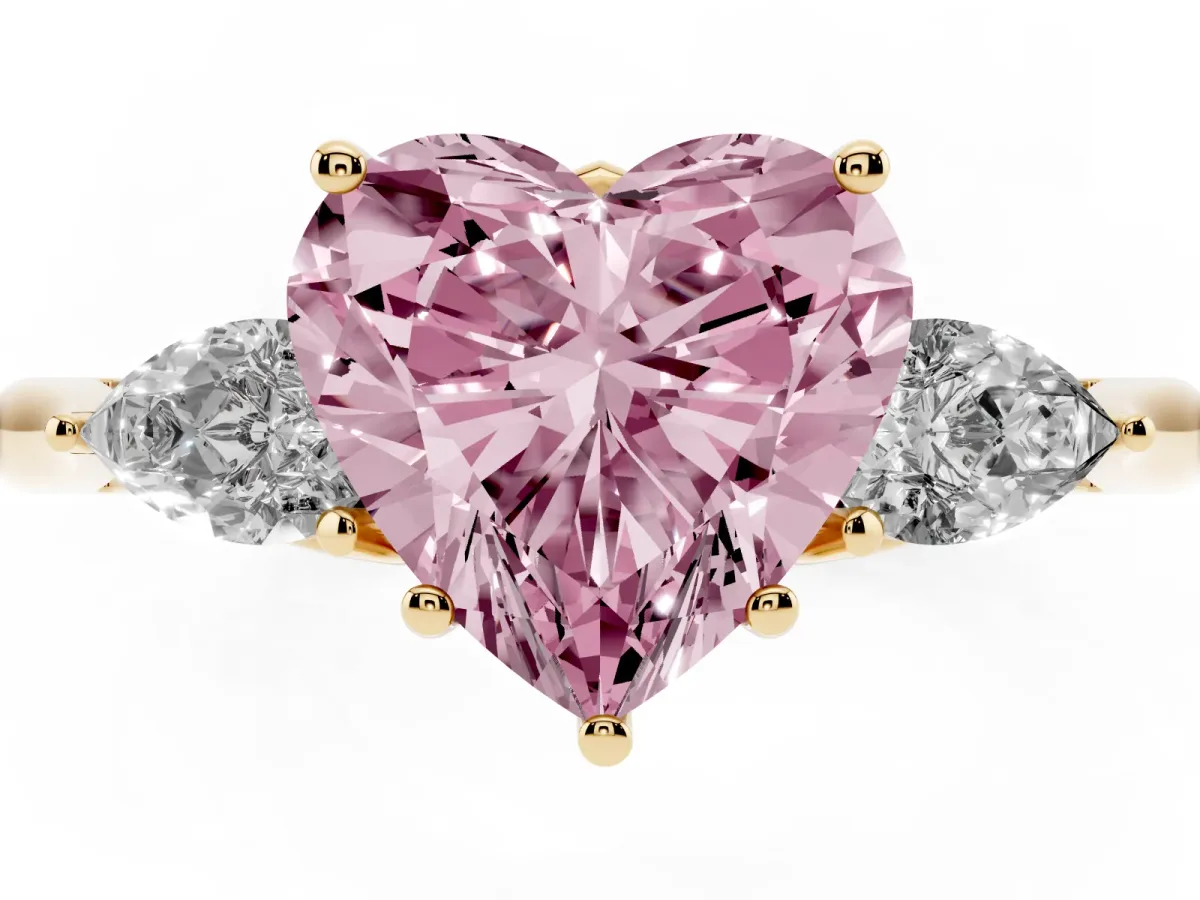 Fancy Pink Three-Stone Heart Cut Diamond Ring with Pear Side Stones in Four-Prong Setting Yellow gold
