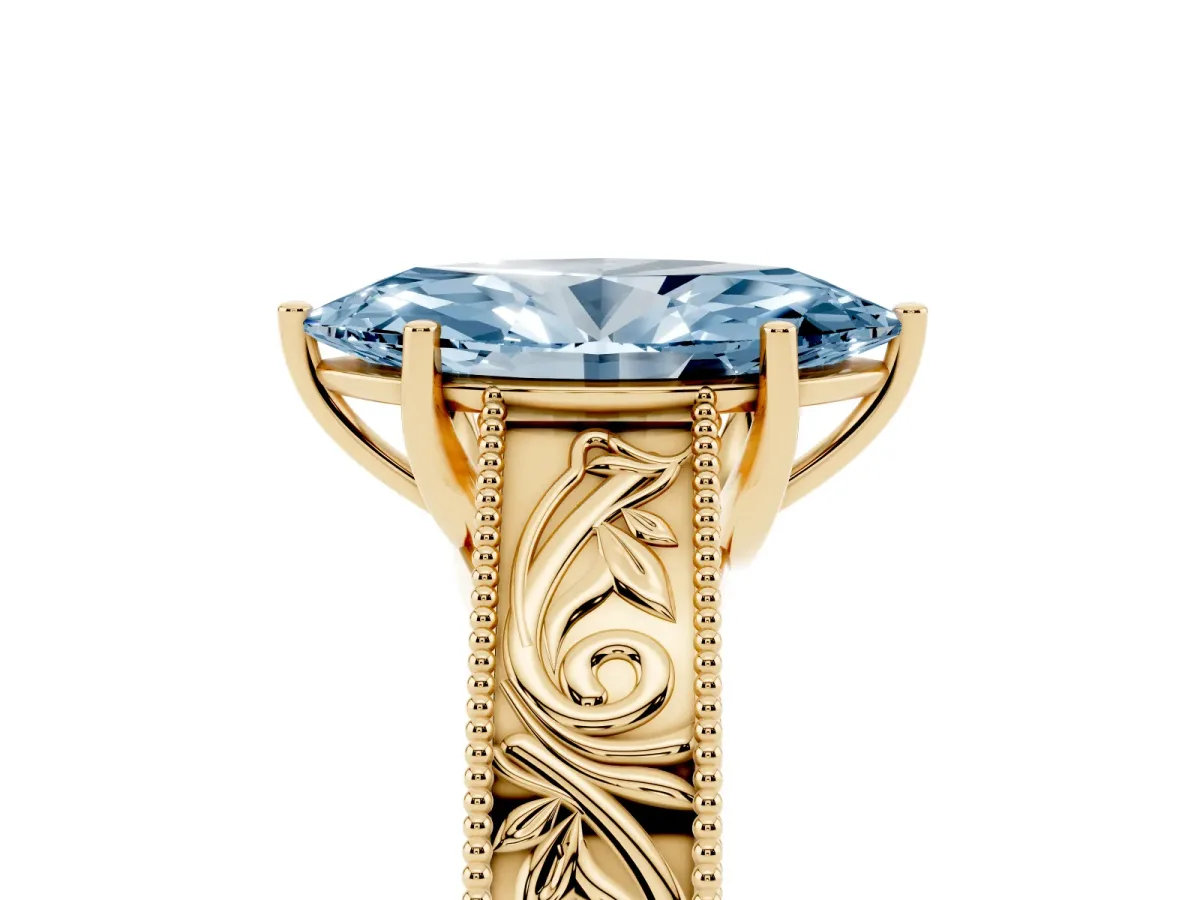 Fancy Blue Marquise Cut Diamond Solitaire Ring with Engraved Band and Four-Prong Setting Yellow gold