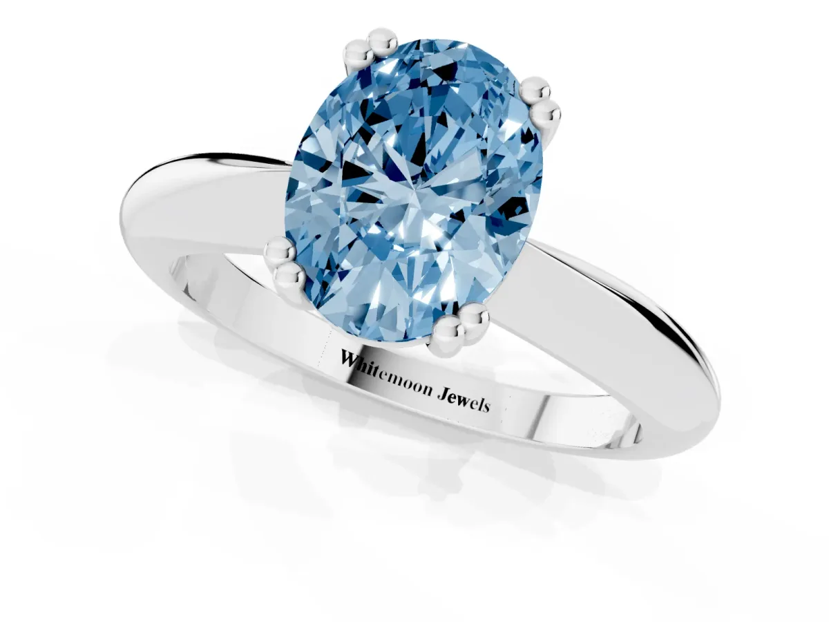 Fancy Blue Oval Cut Cut Solitaire Engagement Ring with Tapered Band and Four-Prong Setting Silver