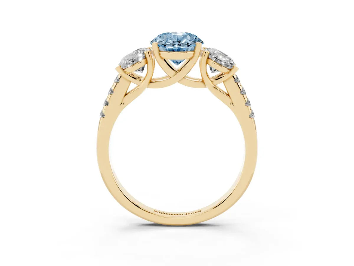 Fancy Blue Three-Stone Oval Cut Diamond Ring with Round Pavé Band and Prong Setting Yellow gold