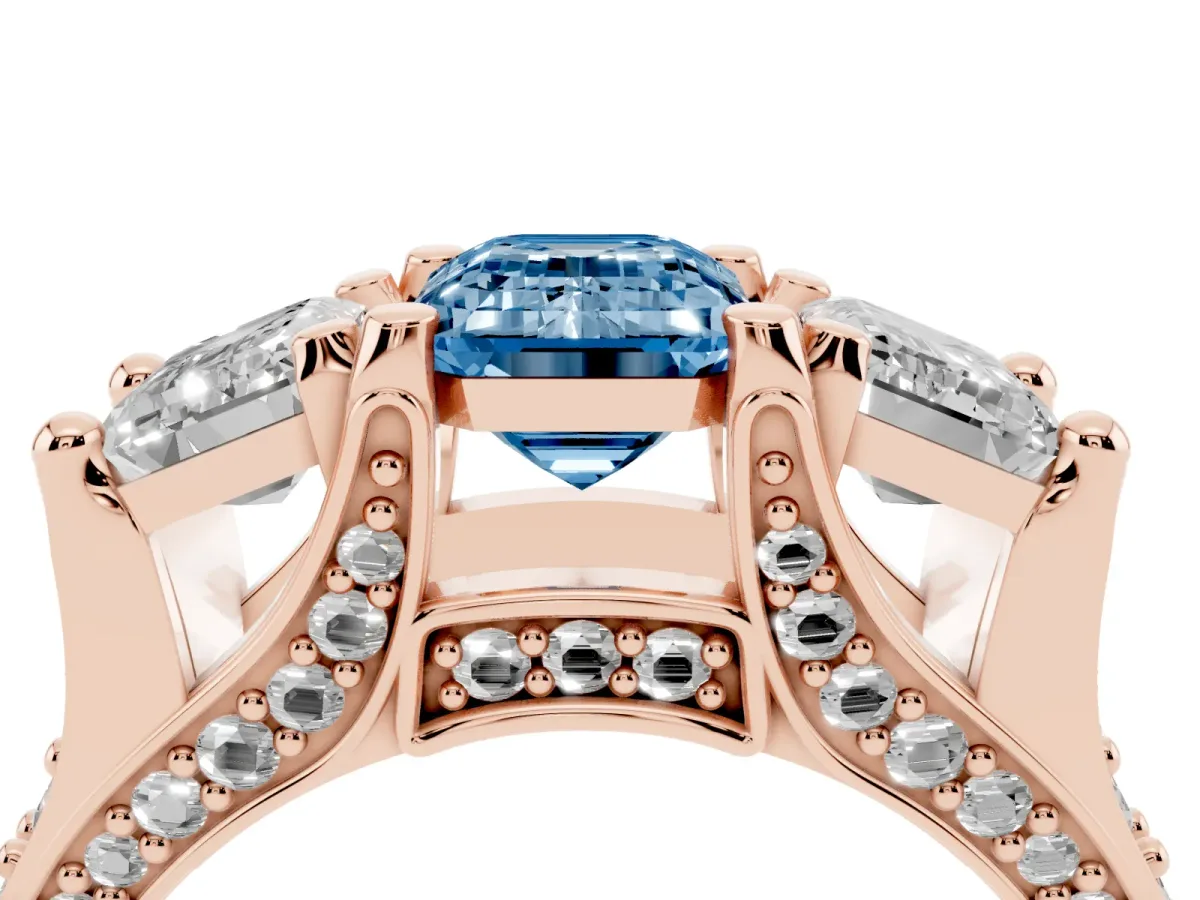Fancy Blue Emerald Cut Diamond Three-Stone Ring with Channel Set Band and Four-Prong Setting Rose gold
