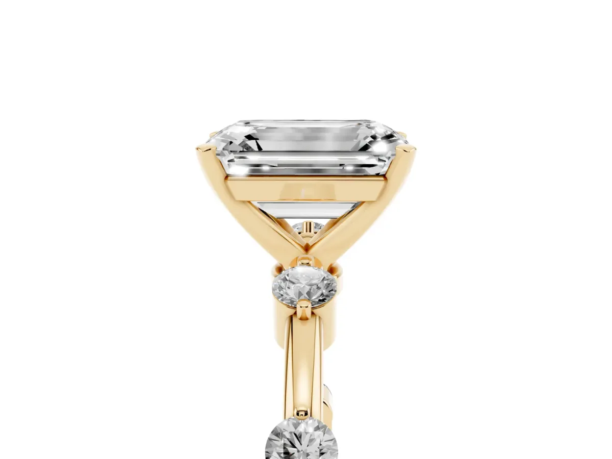 Emerald Cut Solitaire Diamond Ring with Bezel Set Side Stones and Prong Setting Yellow gold