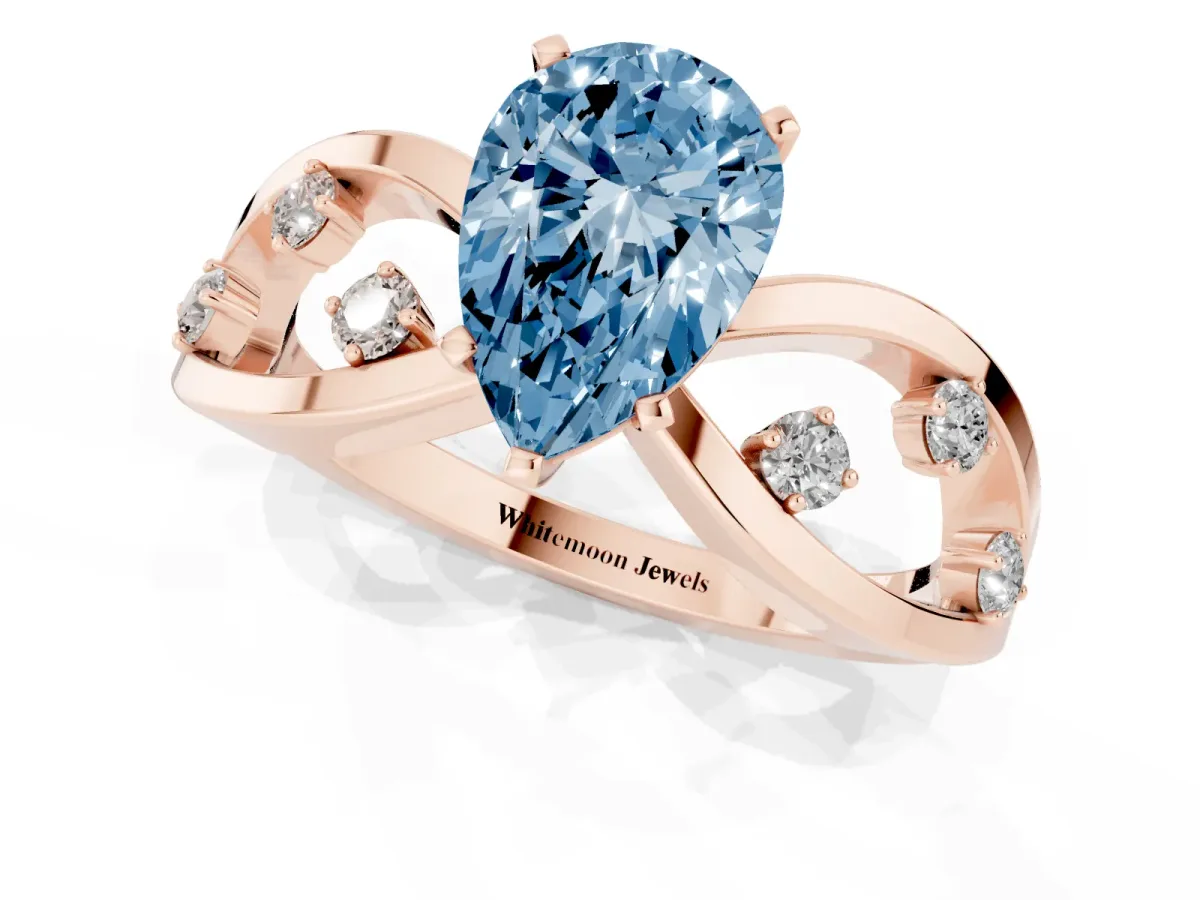 Fancy Blue Pear Cut Cut Solitaire Diamond with Side Stones on Criss-Cross Band and Four-Prong Setting Rose gold